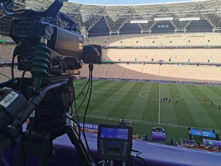 Fixed-position broadcast camera and tracking console at a stadium